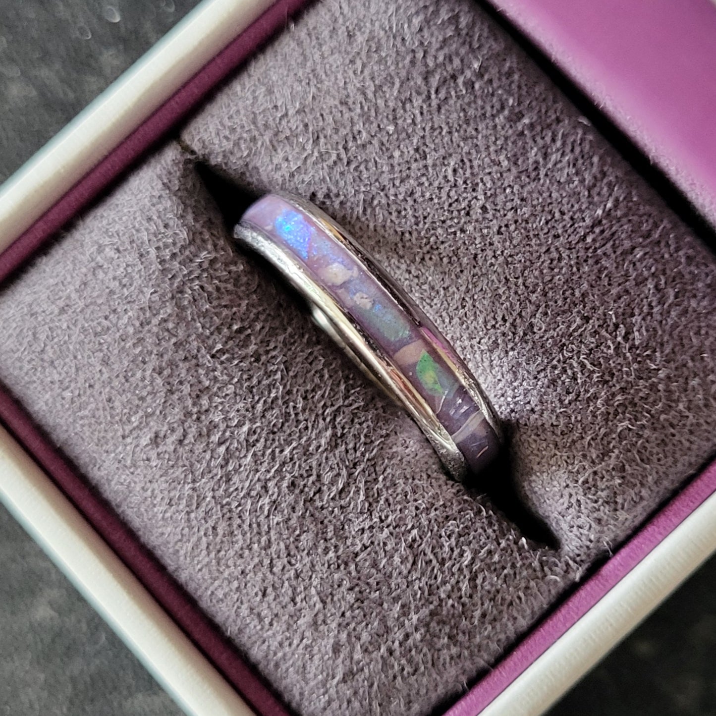 Channel ring containing mylar shards and cremation ashes