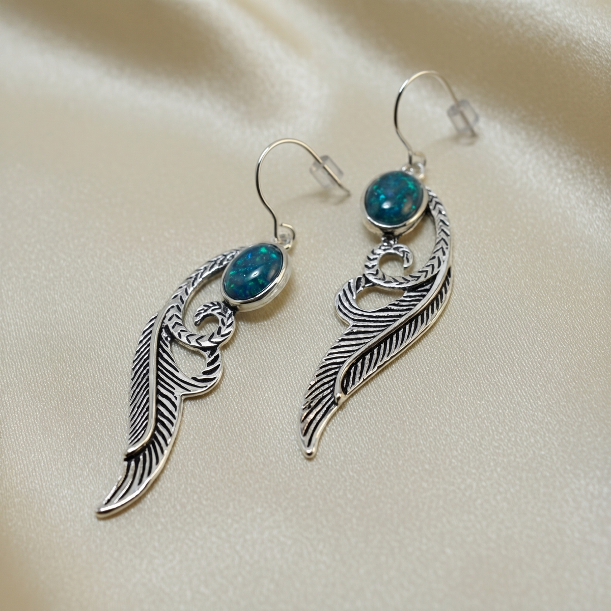 Feather drop style earrings